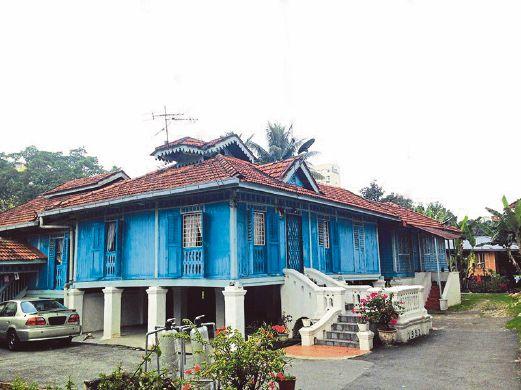 Traditional houses of Kampung Baru against the Kuala Lumpur skyline
