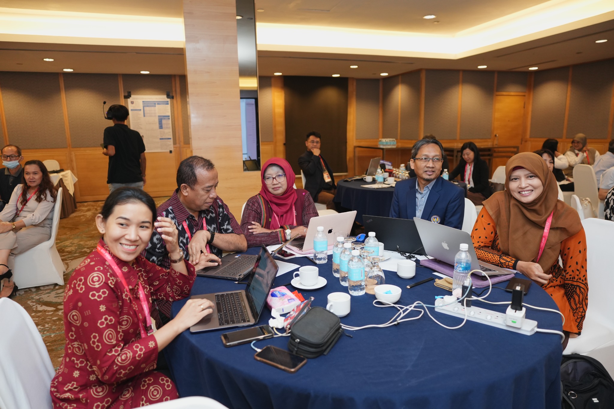 Delegates seated at round tables during the programme