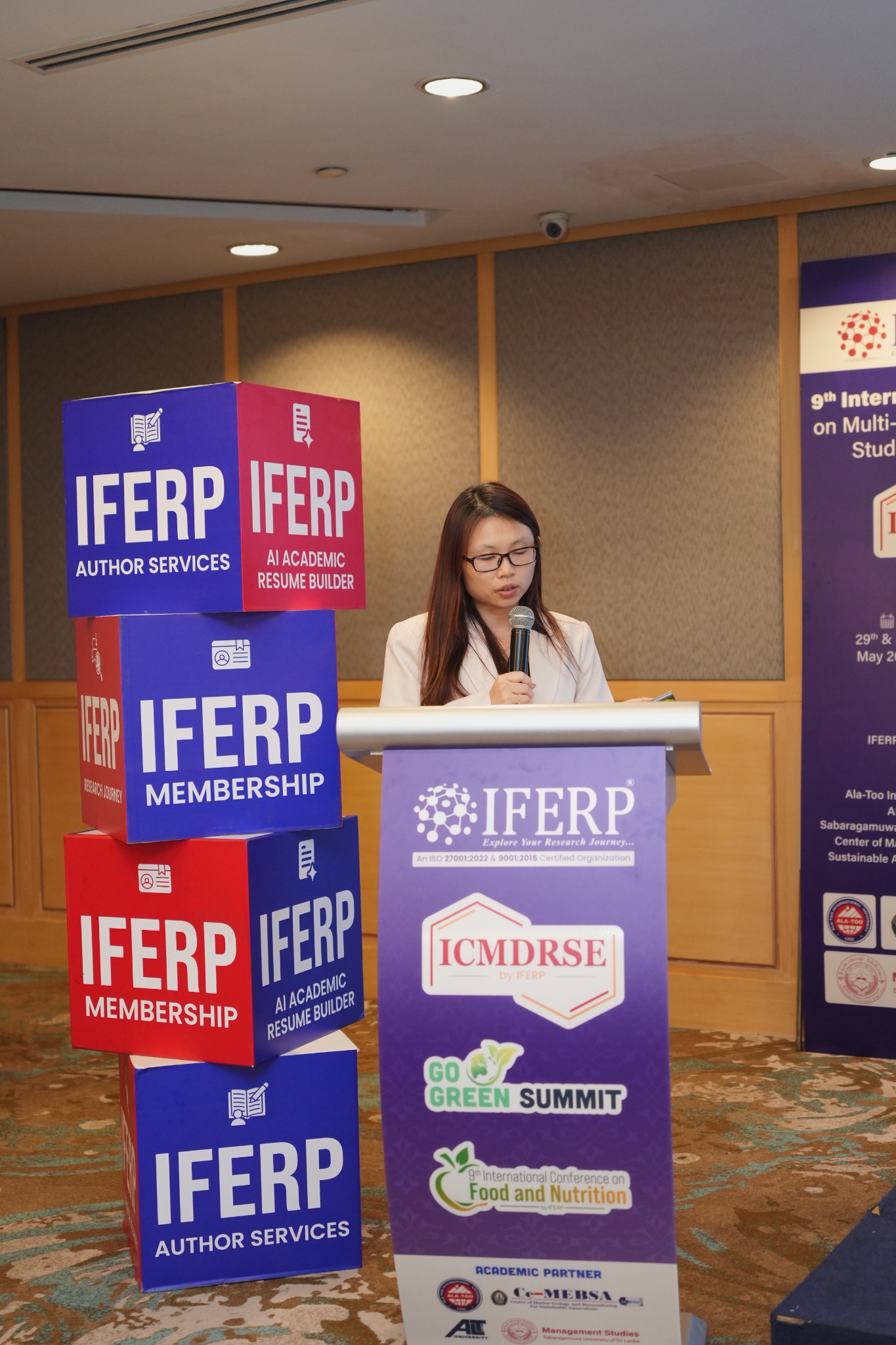 A presenter at the podium during a conference session